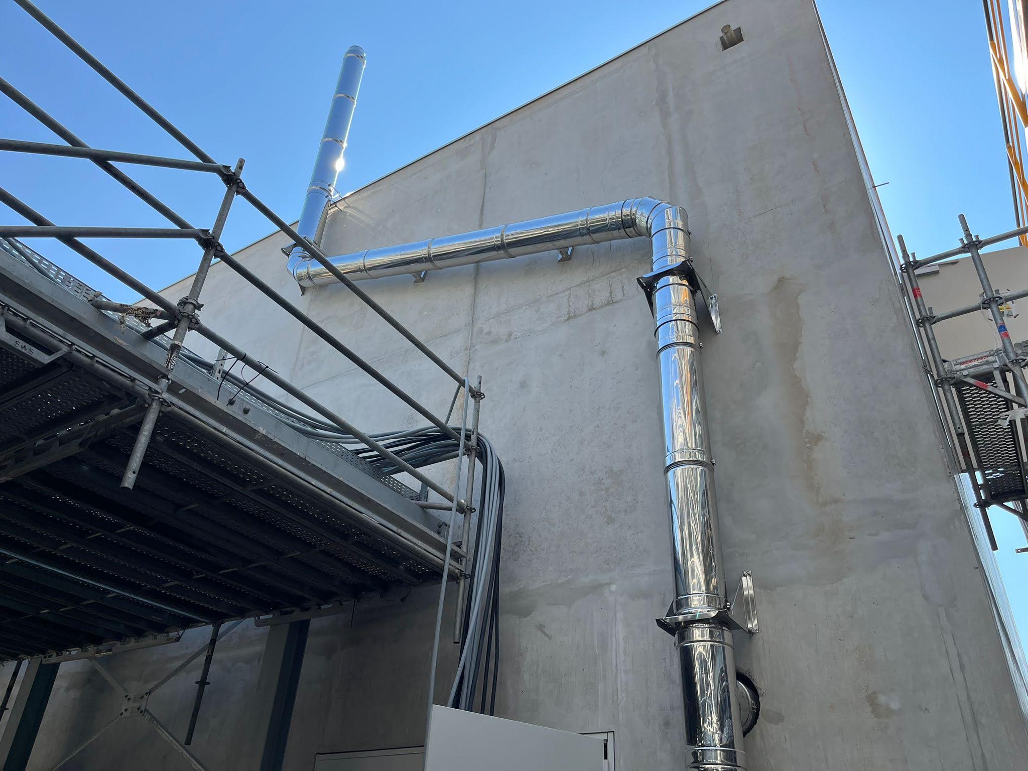 Cheminée d'échappement modulaire en inox sur la façade